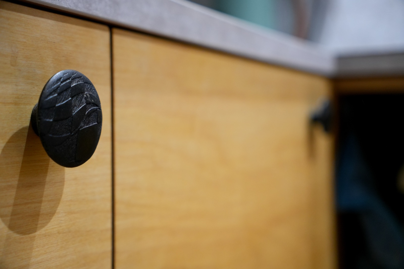 Handcrafted cabinet detail with artisan hardware