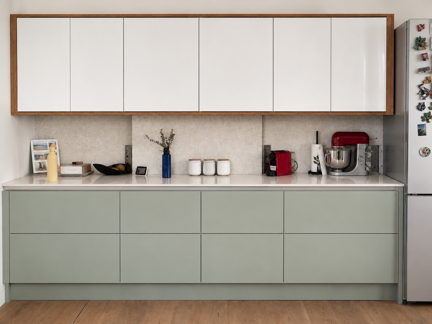 Custom green and white fitted kitchen with oak trim