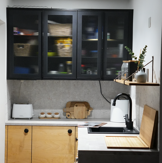 Modern black and oak fitted kitchen with glass-front cabinets