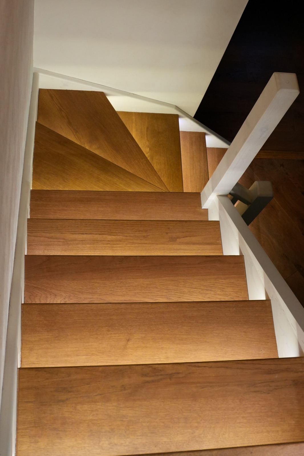 Custom oak staircase with warm lighting